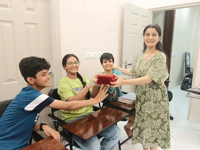 Students at Dr. Deepshikha Classes receiving award and prize from teacher - celebrating academic achievement